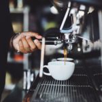 close up of hand holding coffee machine